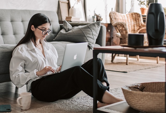 woman sitting on floor with laptop