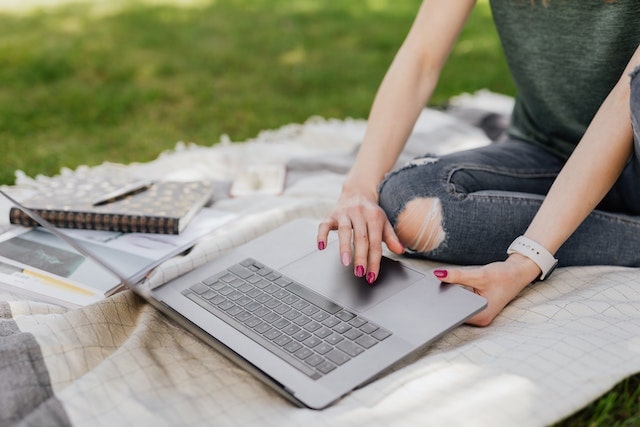 woman typing laptop outside karolina grabowska